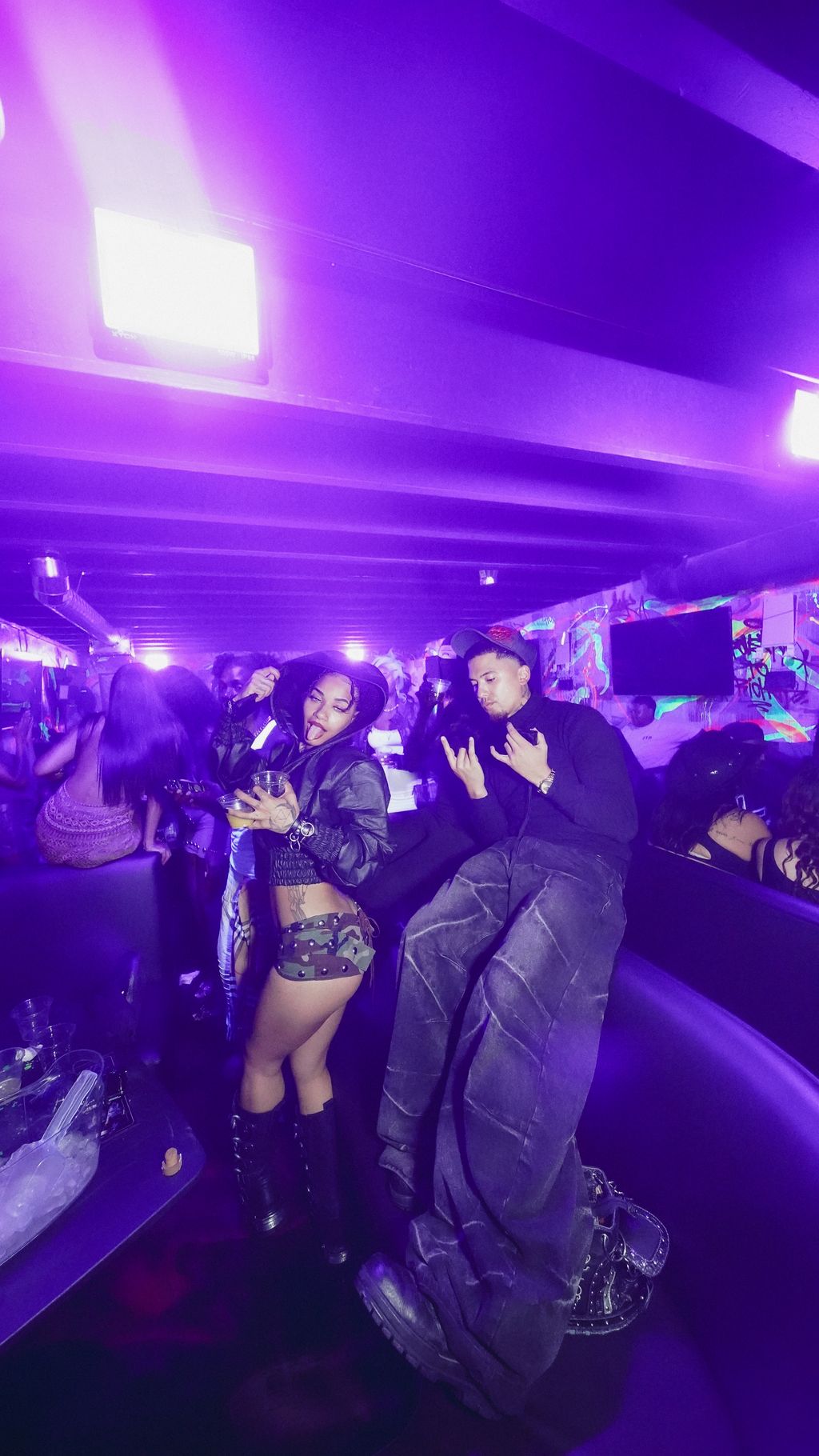 Two guests posing beside the VIP couches